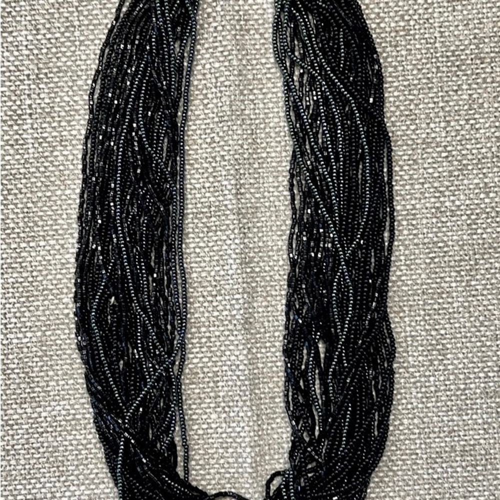 Unique African beaded necklace with elegant black and dark green shimmer beads.